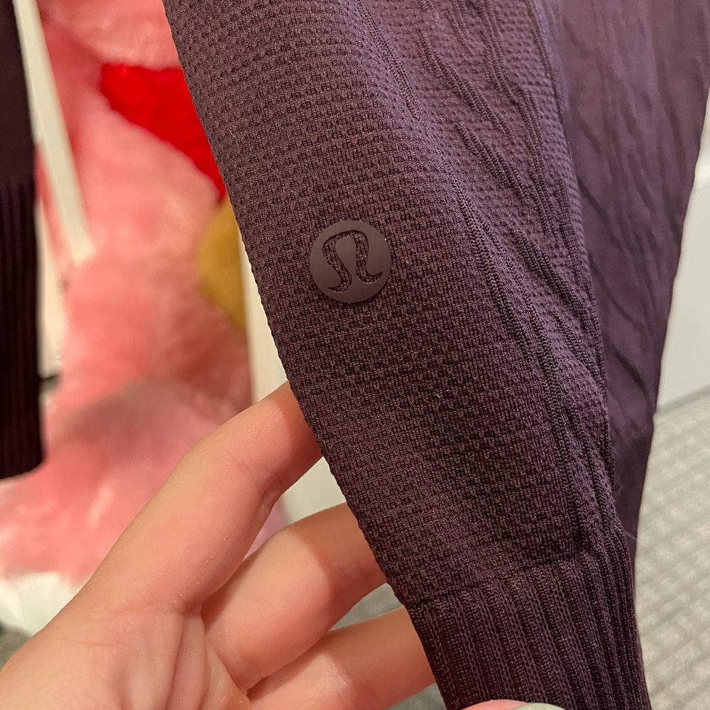 Lululemon long sleeve with hood, sweater embroidery and a deep plum color.